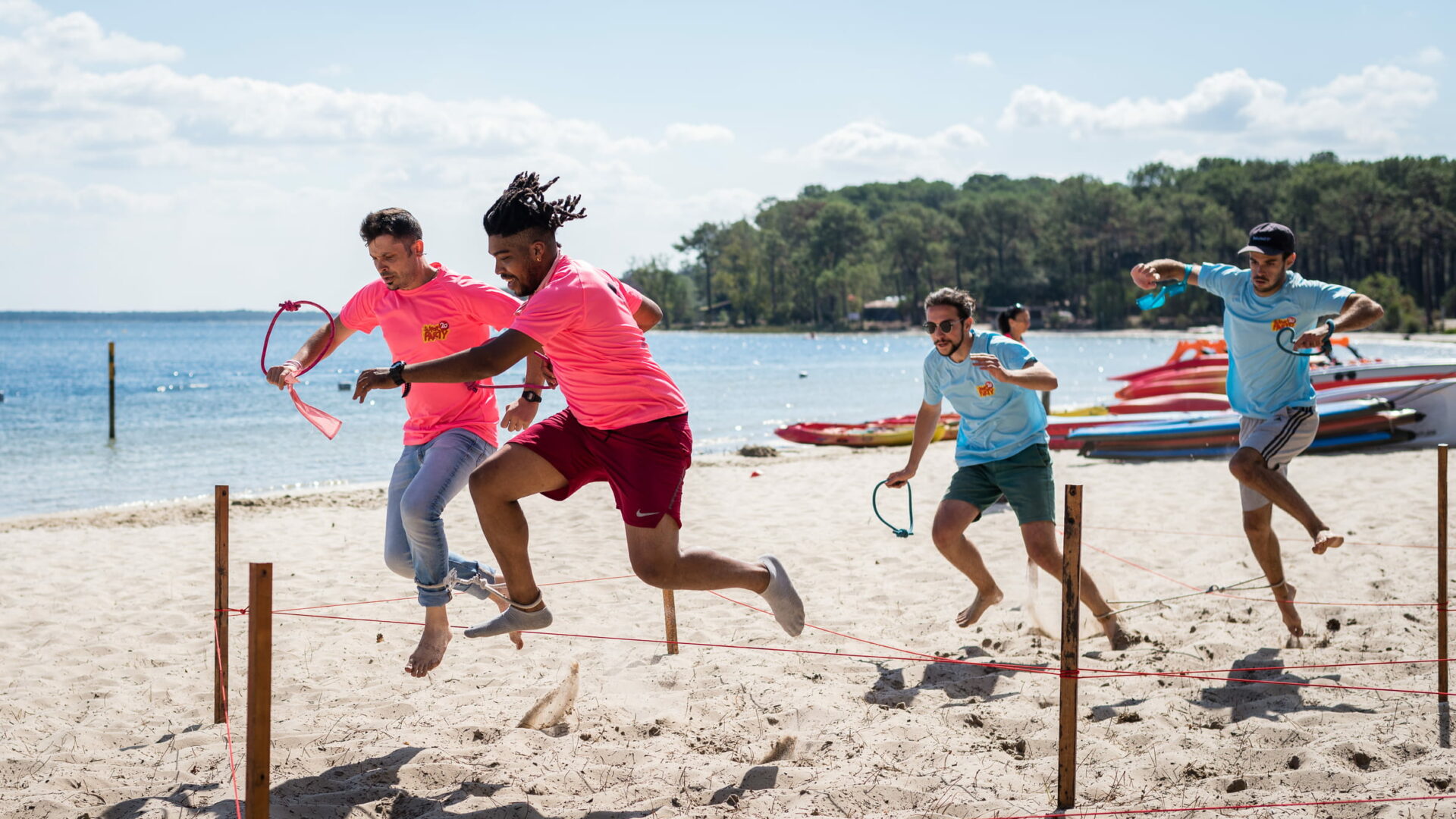 Olympic-style games on a lakeside beach during a team-building event, organised by XXL Happyness